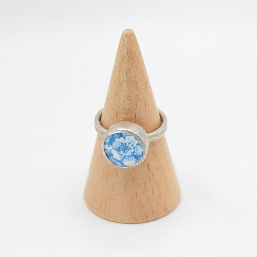 Ceramic Flower Ring from Antique Plate - front view on wooden ring cone, sterling silver bezel setting