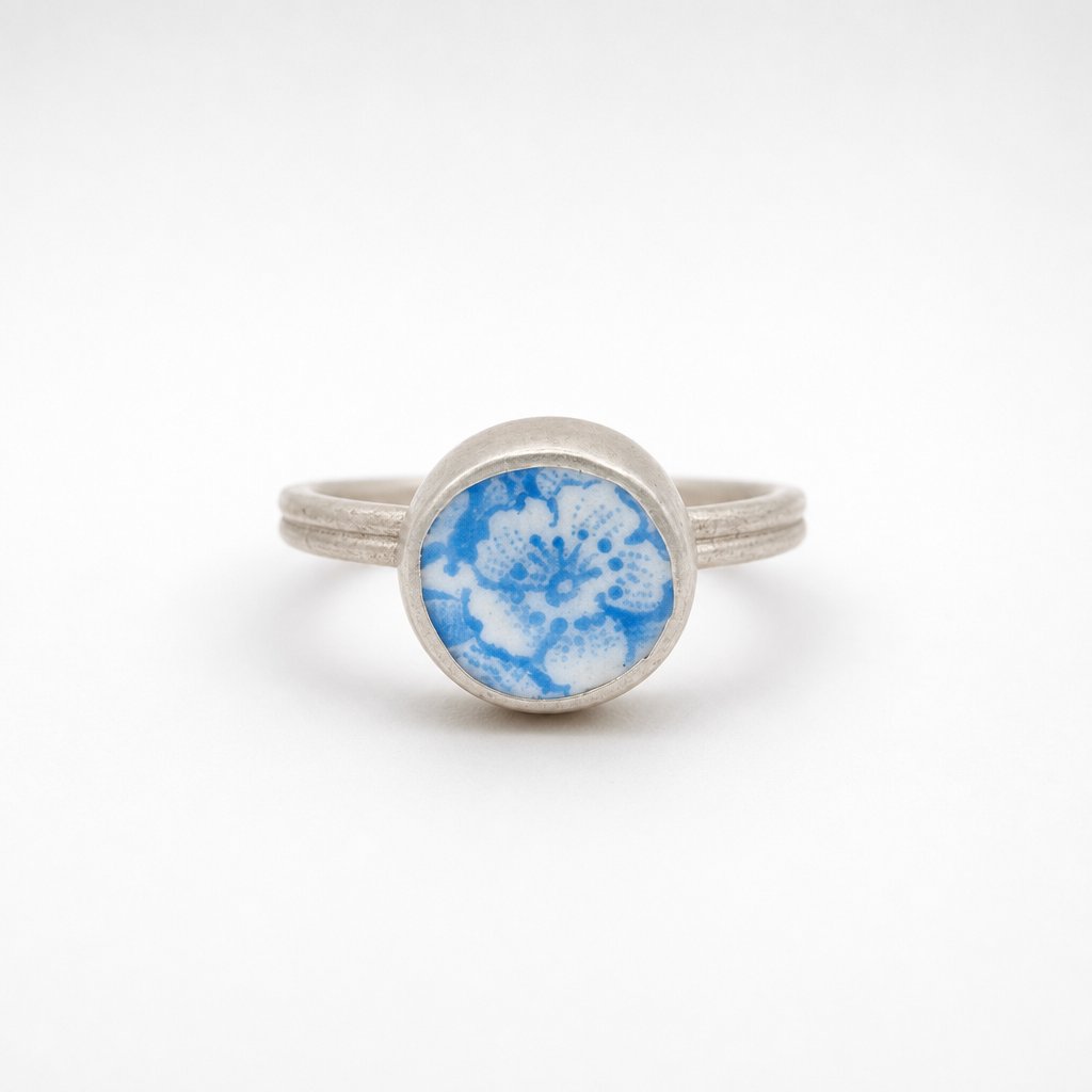 Ceramic Flower Ring from Antique Plate - front view on wooden ring cone, sterling silver bezel setting