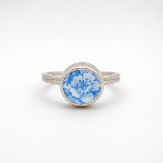 Ceramic Flower Ring from Antique Plate - front view on wooden ring cone, sterling silver bezel setting