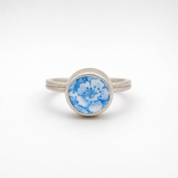 Ceramic Flower Ring from Antique Plate - front view on wooden ring cone, sterling silver bezel setting