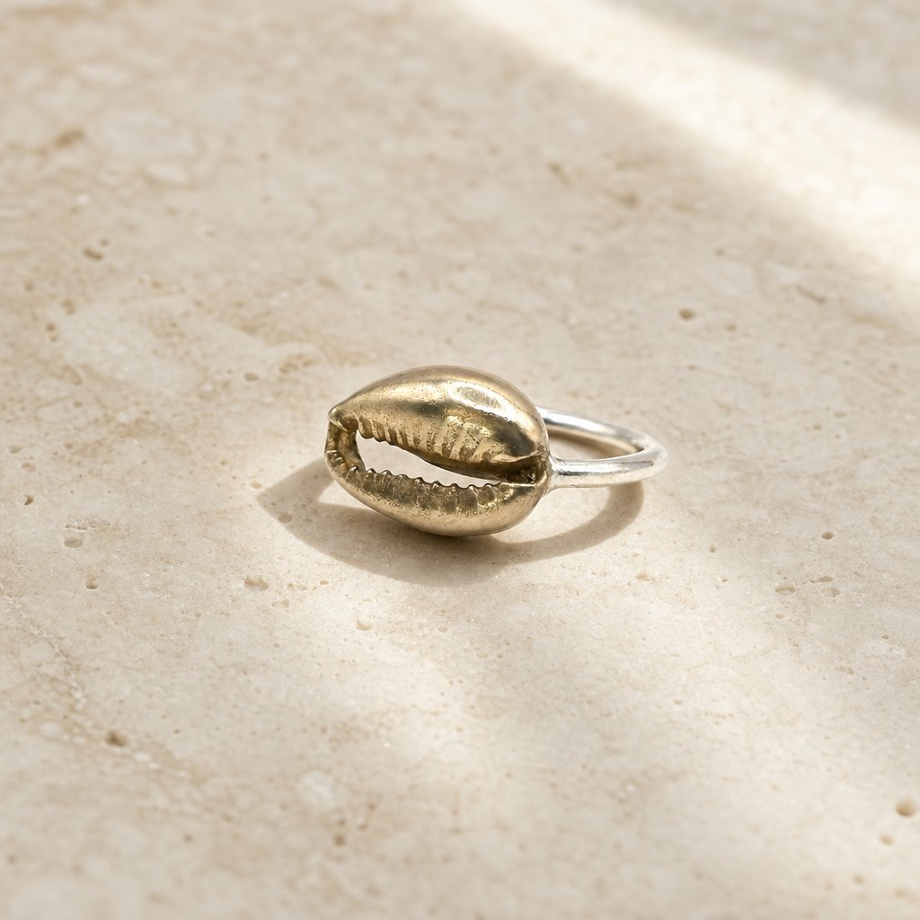 Cowrie Shell Ring - three-quarter view brass cowrie shell sterling silver band Natasha Wood