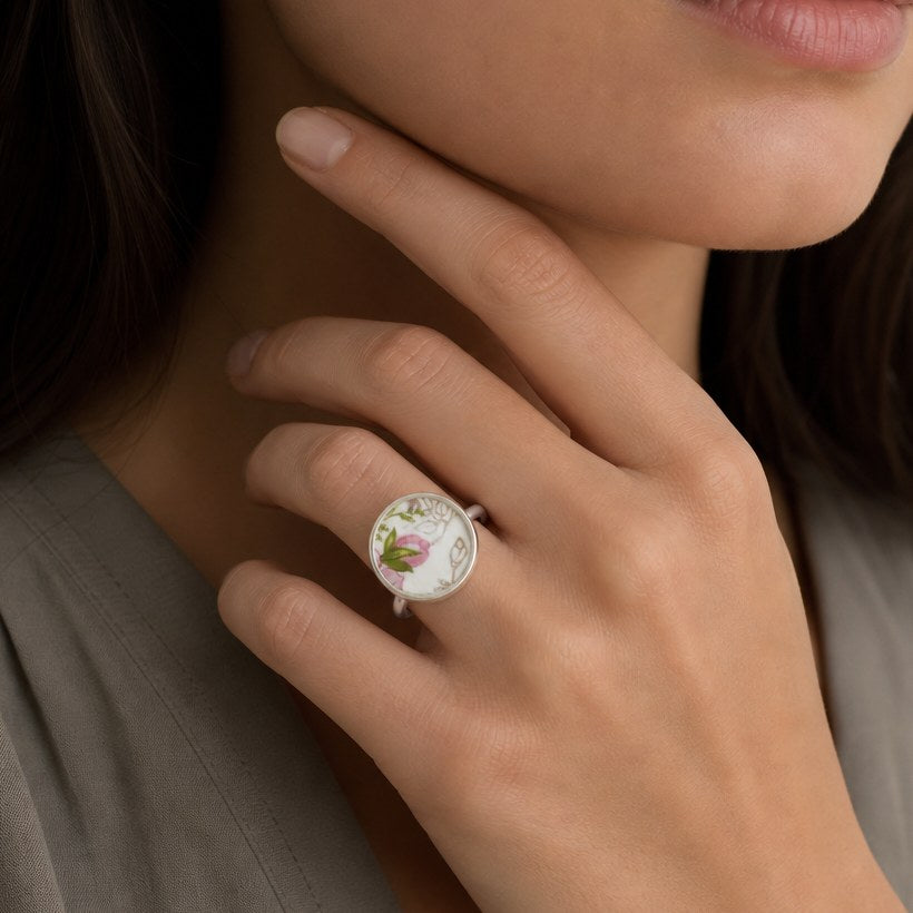 Pink and green floral ceramic sterling silver ring - flat lay hero shot with pink wax flowers