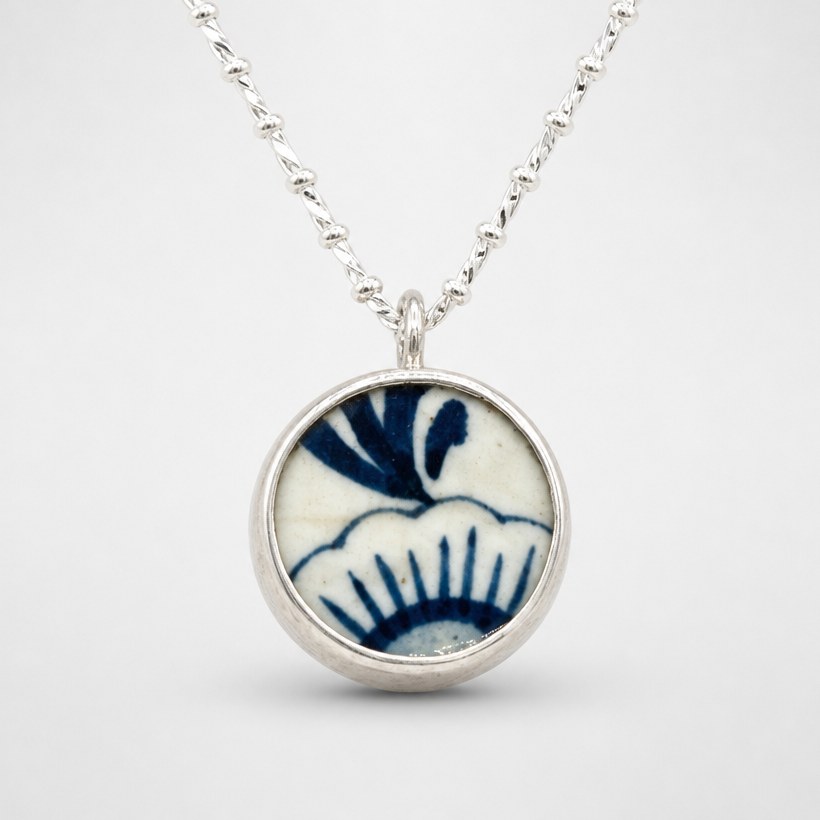 Double-sided broken china pendant – blue willow pattern side – sterling silver bezel setting