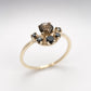 Overhead close-up of custom gold ring with smokey quartz centre stone and black diamond cluster setting - Natasha Wood Jewellery