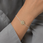 Daisy Flower Bracelet - close-up of brass hand-carved daisy charm detail on sterling silver chain, white background