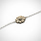 Daisy Flower Bracelet - brass daisy charm on sterling silver chain flat lay showing spring-ring clasp detail, white background