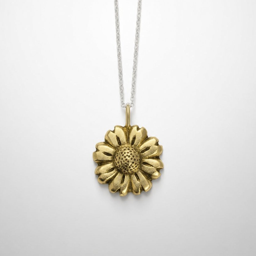 Daisy Flower Pendant - shiny sterling silver on light blue background, handmade by Natasha Wood