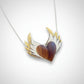 Olive Wood Heart Pendant with Double Silver Wings worn on a sterling silver snake chain at neckline - on-model lifestyle shot