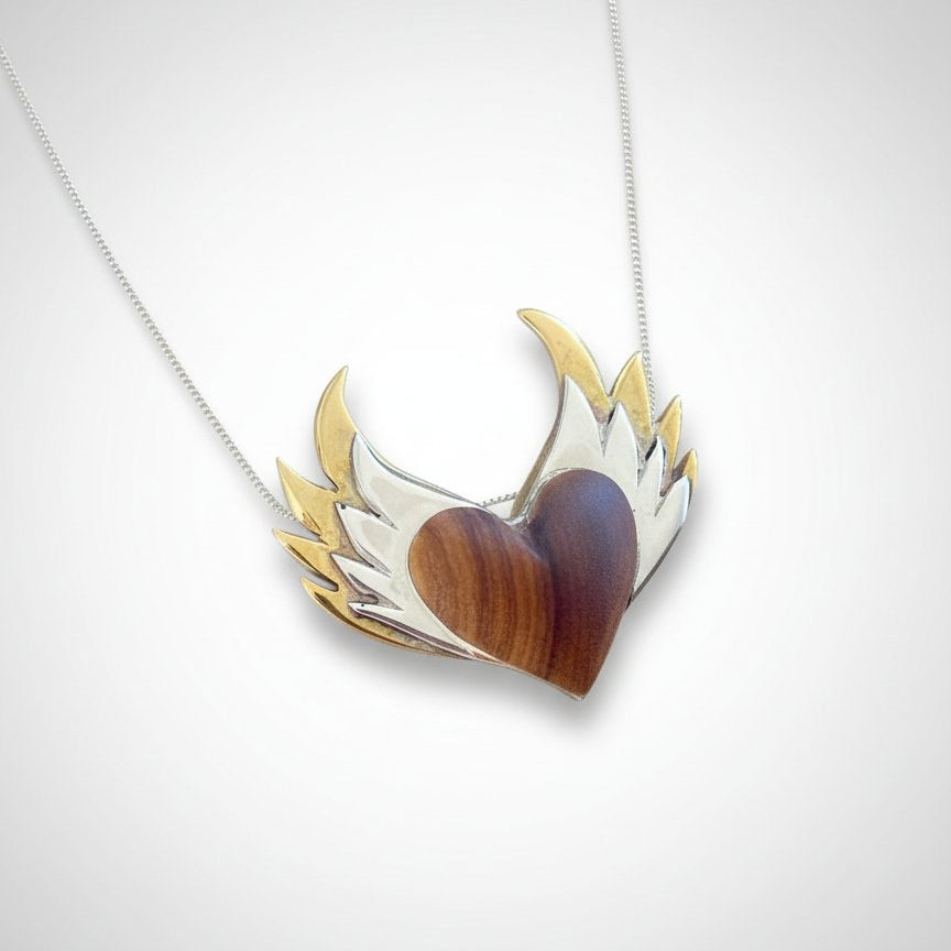 Olive Wood Heart Pendant with Double Silver Wings worn on a sterling silver snake chain at neckline - on-model lifestyle shot