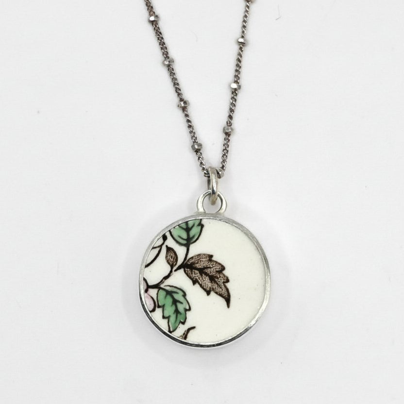 Reversible antique china shard pendant - front face hand-painted floral pattern in sterling silver bezel