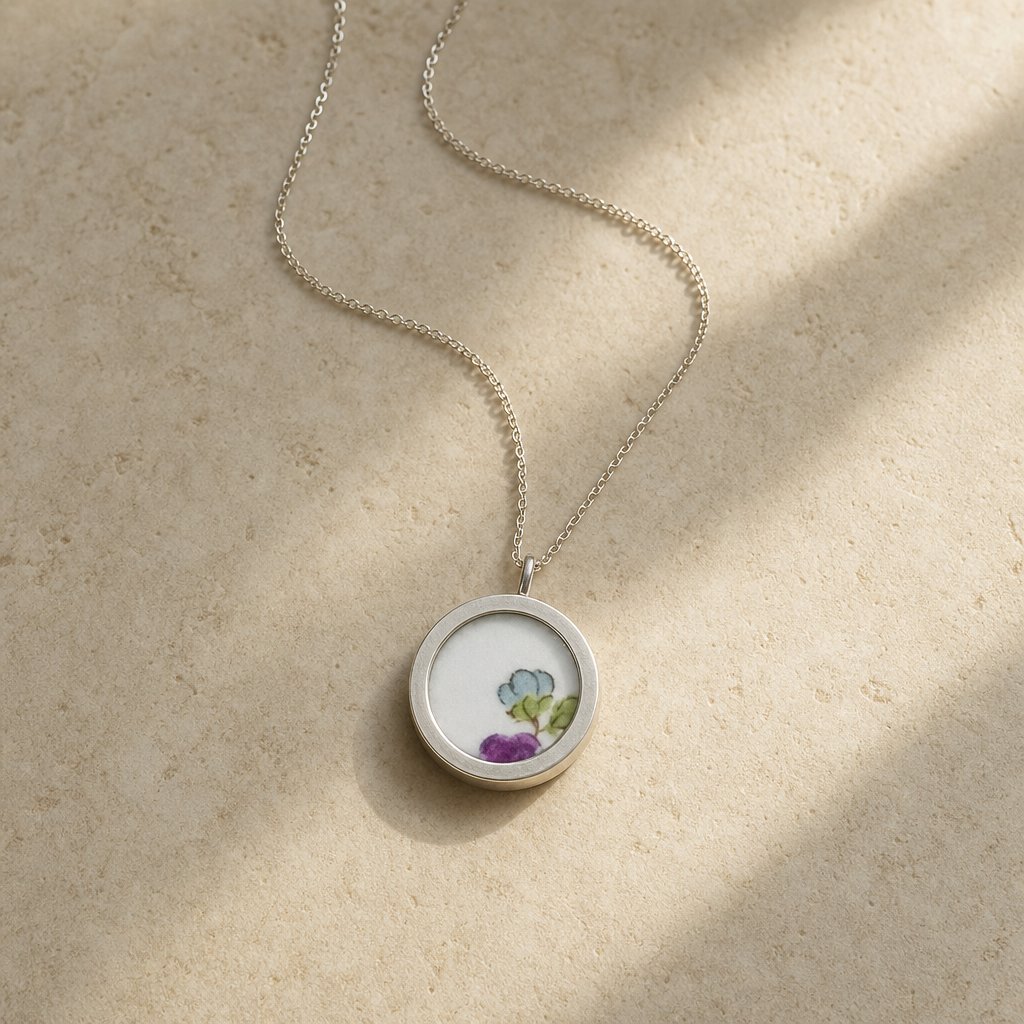 Double-sided broken china pendant - reverse blue willow pattern set in sterling silver bezel