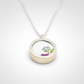 Double-sided broken china pendant - front face floral motif set in sterling silver bezel