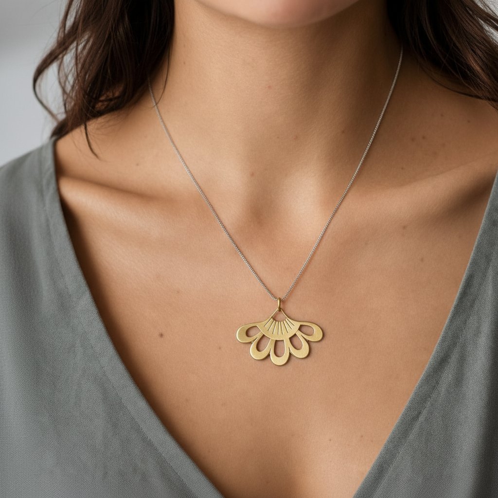 Lotus Flower Pendant - close-up of sterling silver hand-pierced detail on natural wood surface - Natasha Wood Jewellery