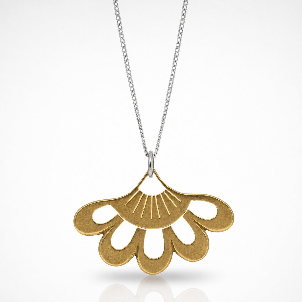 Lotus Flower Pendant - close-up of sterling silver hand-pierced detail on natural wood surface - Natasha Wood Jewellery