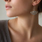 Five-Petal Lotus Hook Earrings - sterling silver pair hanging, showing cut-out petal design and polished finish