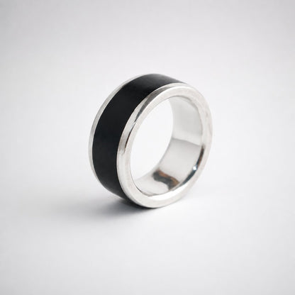 African Blackwood and sterling silver men's band ring - three-quarter view showing wood inlay and silver shoulders
