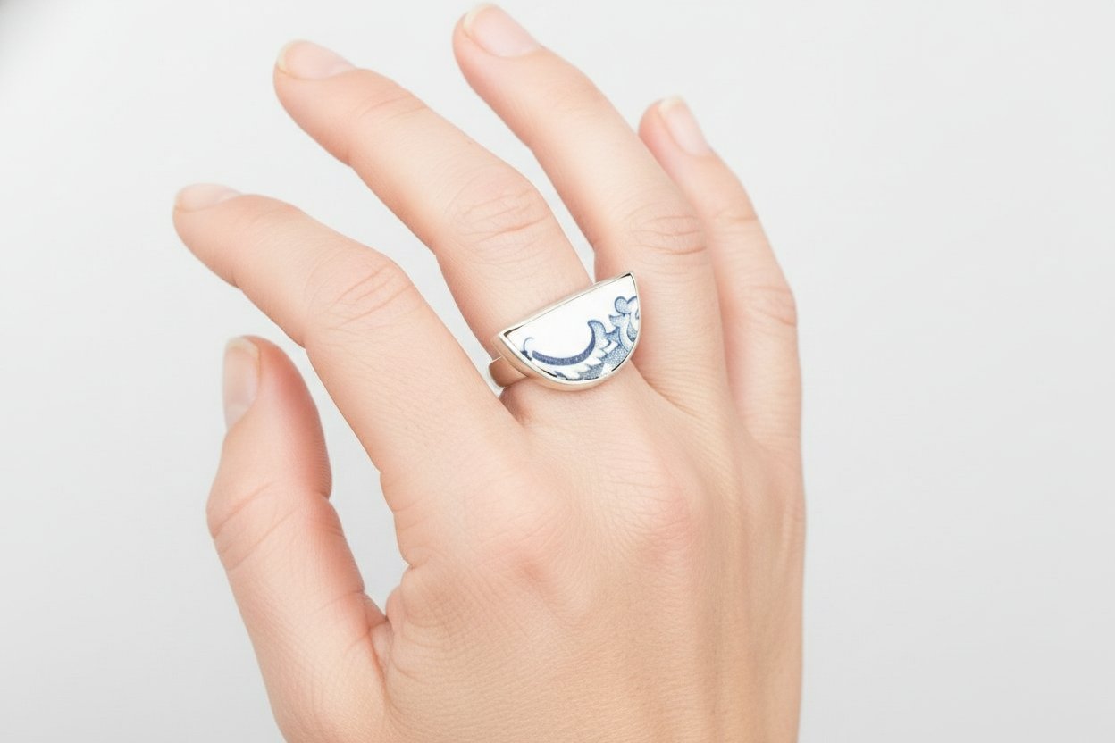 Antique blue and white ceramic half round ring set in sterling silver - three-quarter angle on white background