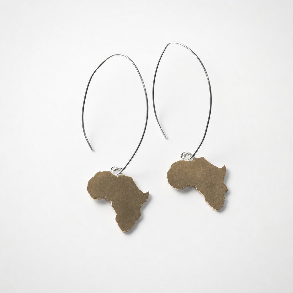 Large Africa Hook Earrings - pair flat-lay, hand-pierced brass Africa pendants on long sterling silver hooks