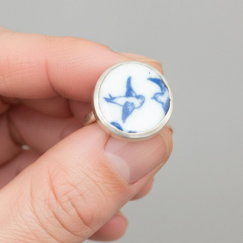 Lovebird Ring - worn on hand showing scale, antique willow pattern blue ceramic bezel set in sterling silver, size UK Q