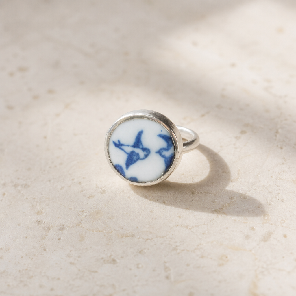 Lovebird Ring - displayed on wooden ring cone stand, antique willow pattern blue and white ceramic set in sterling silver bezel