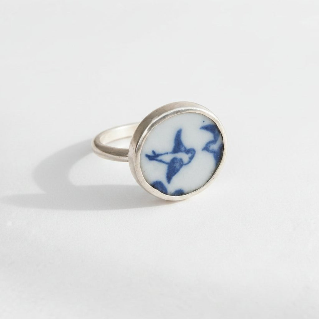 Lovebird Ring - displayed on wooden ring cone stand, antique willow pattern blue and white ceramic set in sterling silver bezel