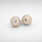 Medium Urchin Hook Earrings in sterling silver - coastal lifestyle shot on textured rock, showing urchin form