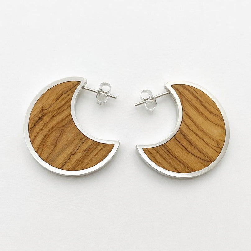 Moon Stud Earrings - olive wood crescent studs angled view showing sterling silver bezel depth and dark wood insert