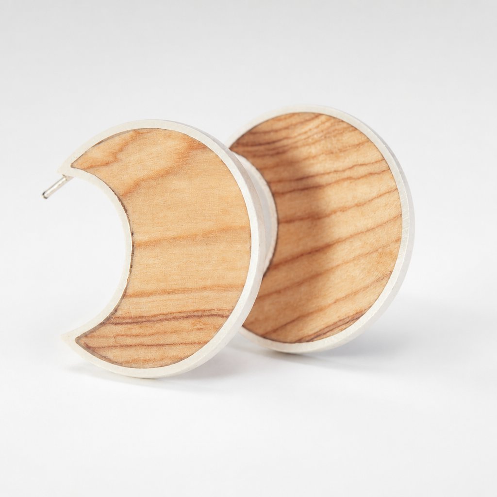 Moon Stud Earrings with Olive Wood - flat lay pair showing crescent shape and natural wood grain with sterling silver bezel