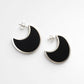Moon Stud Earrings - African Blackwood crescent studs angled view showing sterling silver bezel depth and dark wood insert