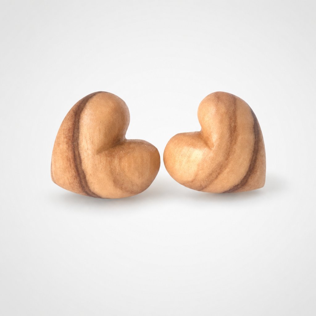 Natasha Wood Jewellery olive wood heart stud earrings - front view, natural grain, sterling silver backs, white background