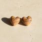 Natasha Wood Jewellery olive wood heart stud earrings - front view, natural grain, sterling silver backs, white background