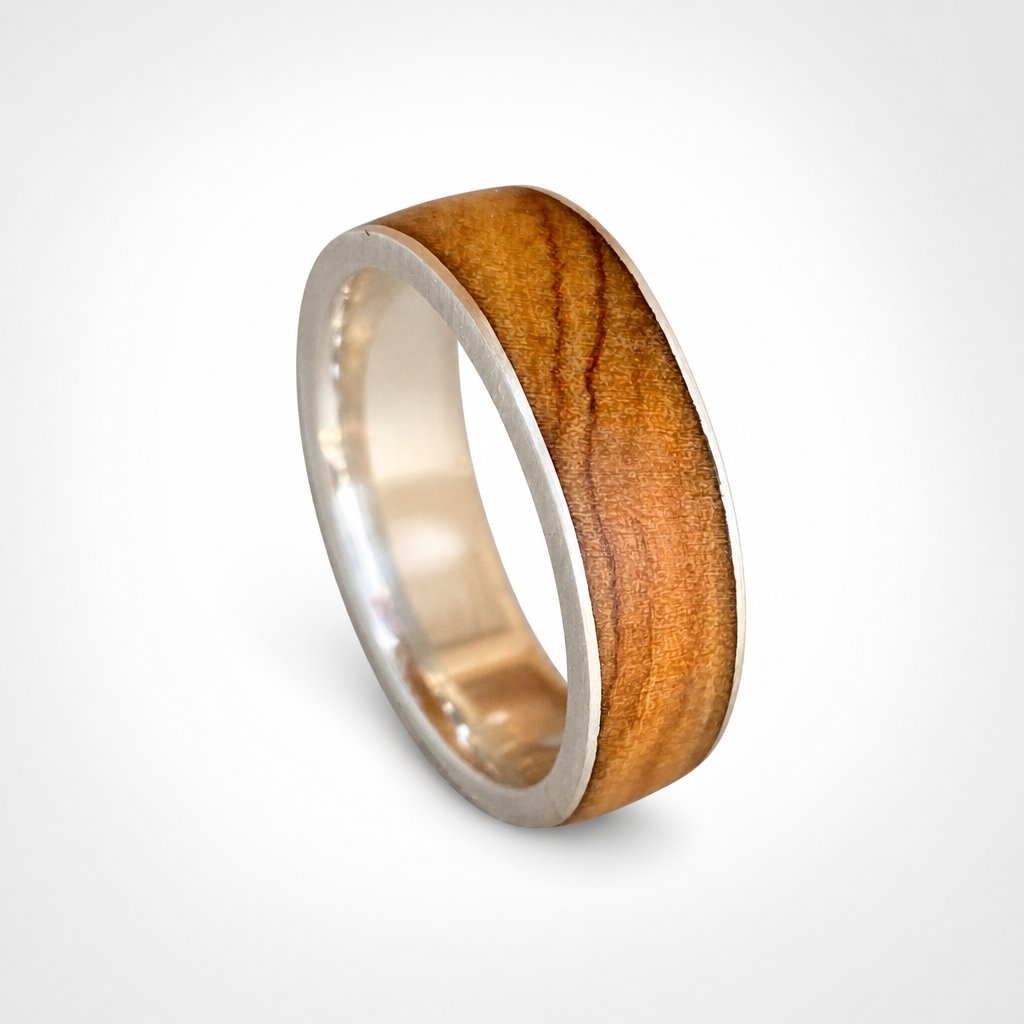 Olive Wood & Sterling Silver Ring - angled hero view showing wood grain and silver band