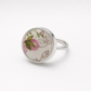 Pink and green floral ceramic sterling silver ring - flat lay hero shot with pink wax flowers
