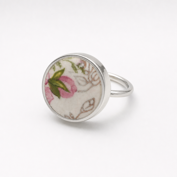 Pink and green floral ceramic sterling silver ring - flat lay hero shot with pink wax flowers