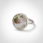 Pink and green floral ceramic sterling silver ring - flat lay hero shot with pink wax flowers