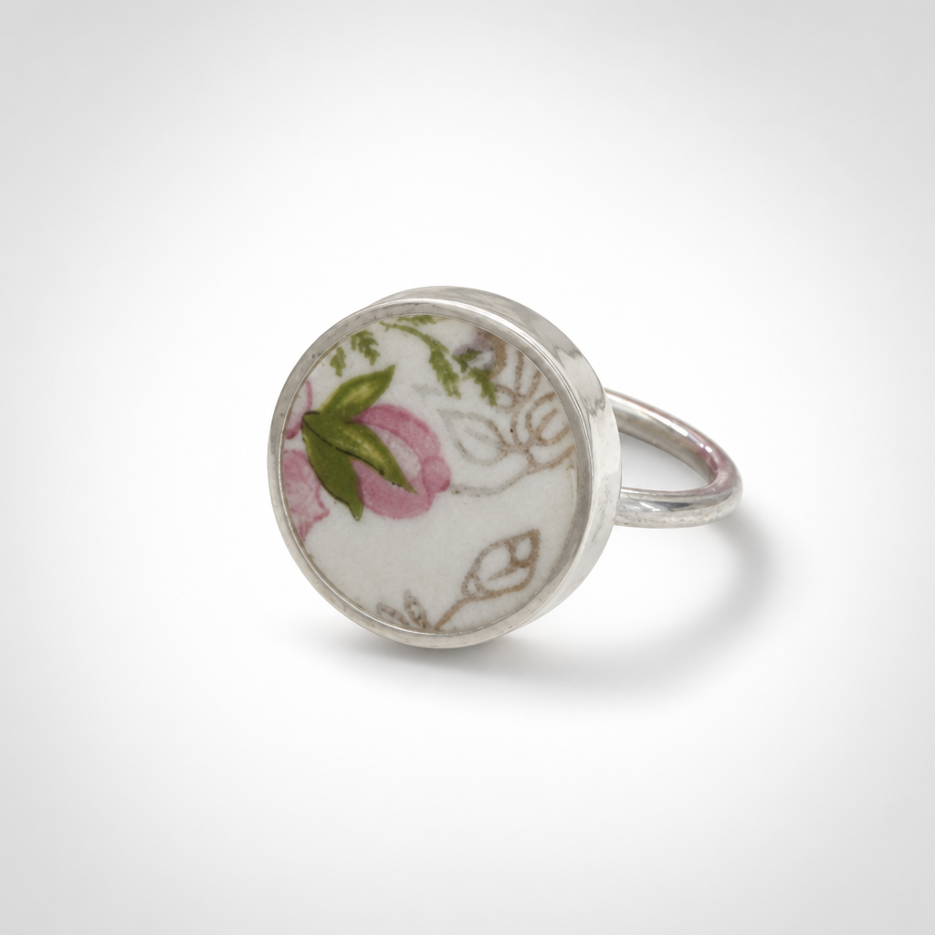 Pink and green floral ceramic sterling silver ring - flat lay hero shot with pink wax flowers