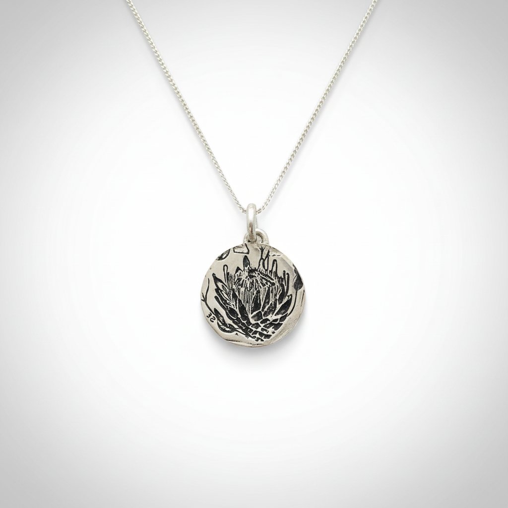 Silver Protea Disc Pendant - side profile view showing disc thickness and handcrafted edge on sterling silver chain