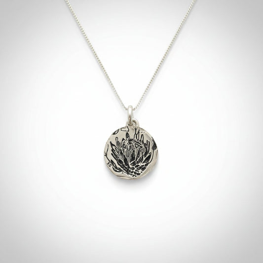 Silver Protea Disc Pendant - side profile view showing disc thickness and handcrafted edge on sterling silver chain