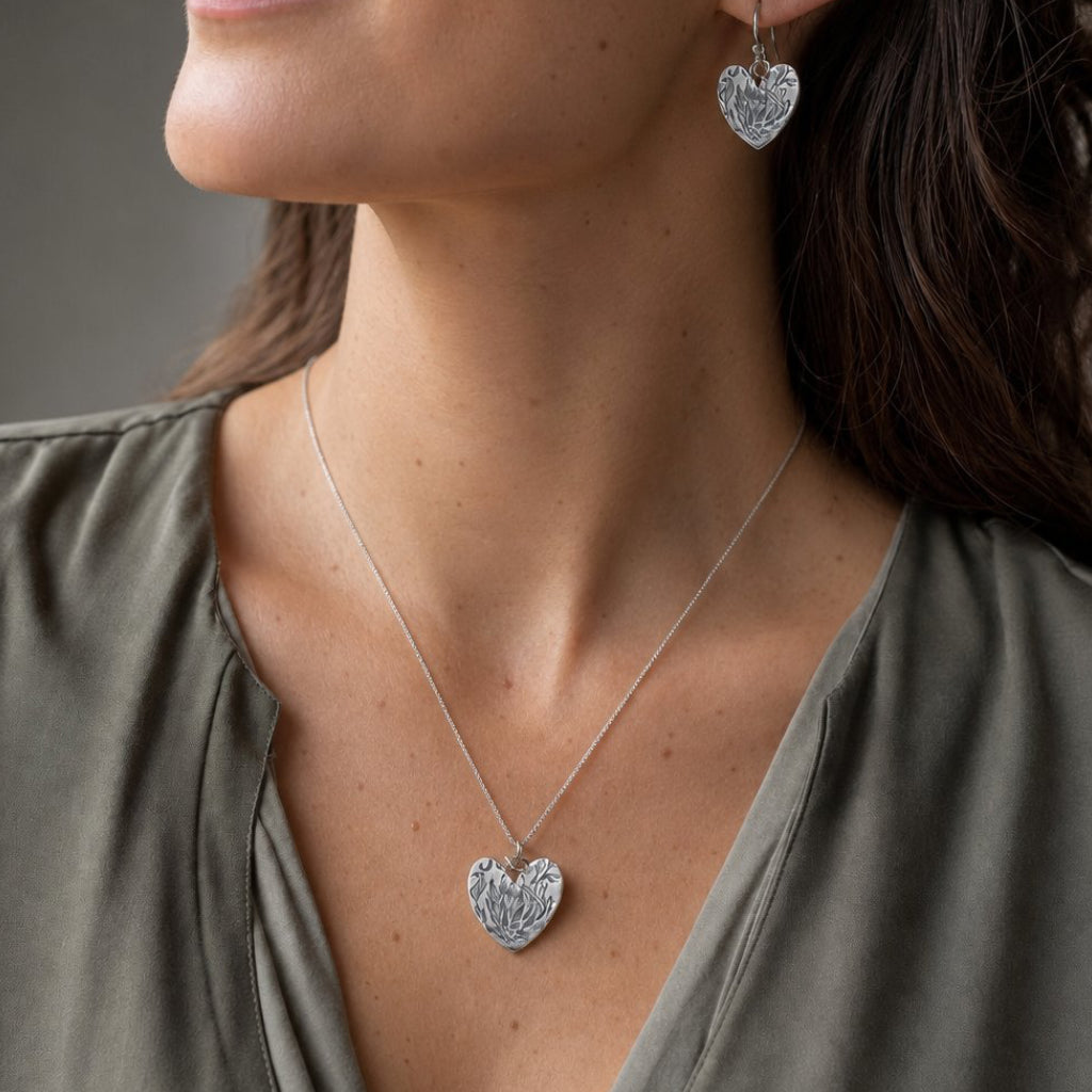 Handcrafted Protea Heart Hook Earrings - flat lay product shot sterling silver etched detail