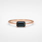 Bespoke rose gold ring with emerald-cut black diamond - four-claw solitaire on white fabric background