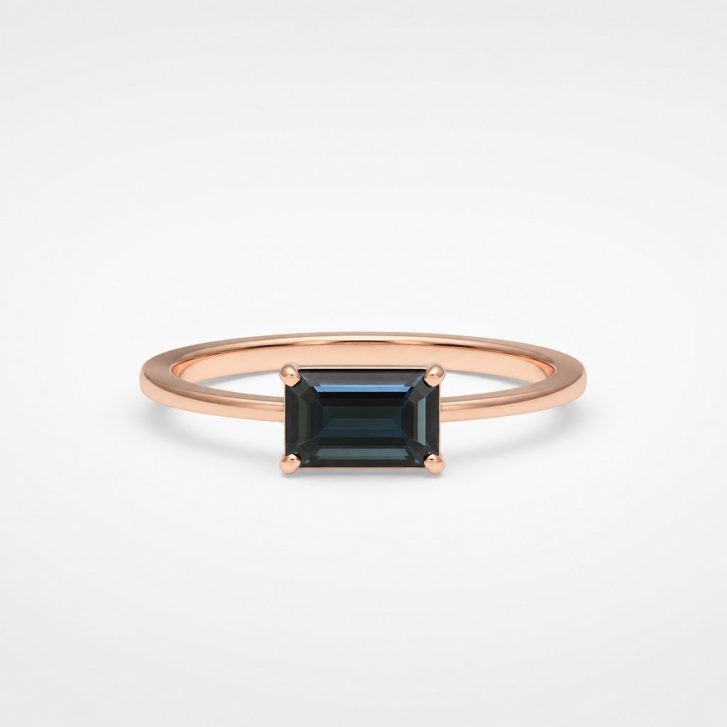 Bespoke rose gold ring with emerald-cut black diamond - four-claw solitaire on white fabric background