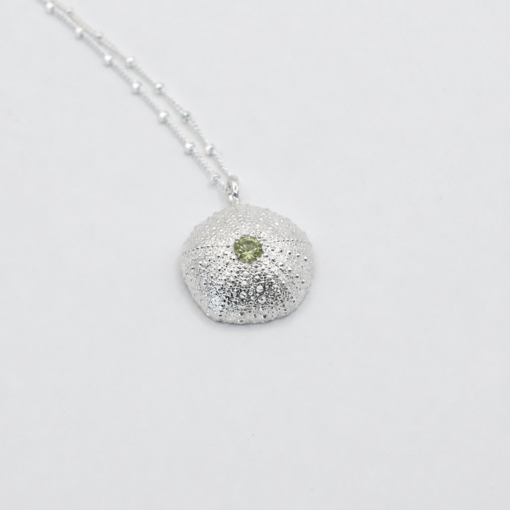 Large Sterling Silver Sea Urchin Pendant with Blue Topaz hanging on satellite chain - suspended shot gradient background