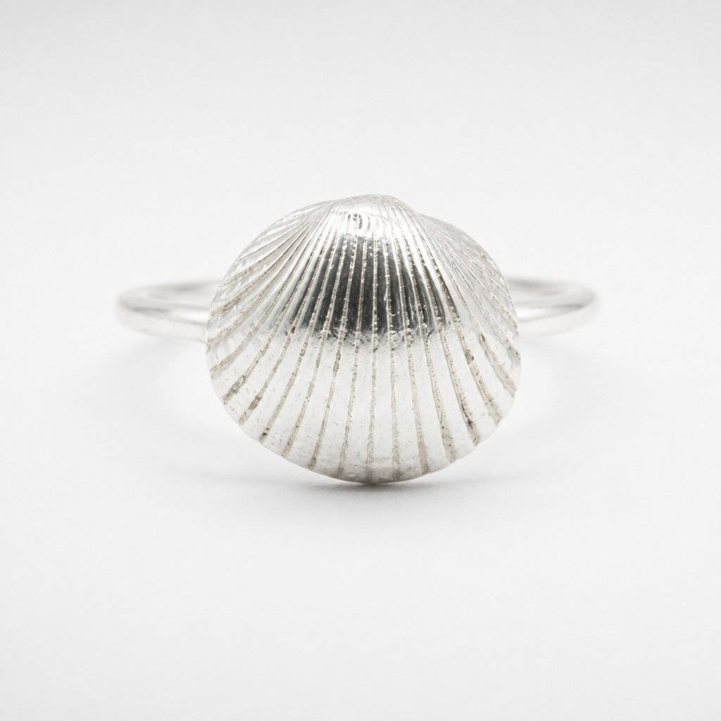 Sterling Silver Scallop Shell Ring - flat lay front view showing ribbed shell texture and band