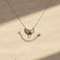 Brass Heart with Silver Wings Necklace - close-up detail, oxidised sterling silver wings and brass heart