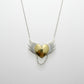 Brass Heart with Silver Wings Necklace - hero flat lay, mixed metal pendant on white background