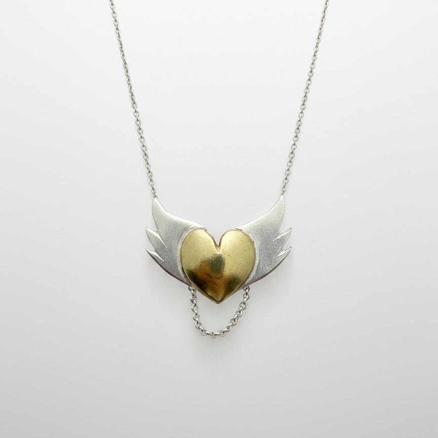 Brass Heart with Silver Wings Necklace - hero flat lay, mixed metal pendant on white background
