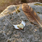 Brass Heart with Silver Wings Necklace - hero flat lay, mixed metal pendant on white background