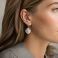 Small Pansy Shell Drop Earrings - brass variant angled view showing petal and groove detail