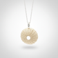 medium Sea Urchin Pendant - brass variant front view with sterling silver curb chain, studio background