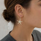 Starfish Earrings - brass finish flat lay showing warm golden tone and intricate cast texture